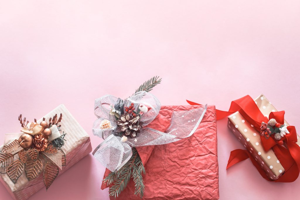 Beautiful gift festive box on pink background, holidays concept